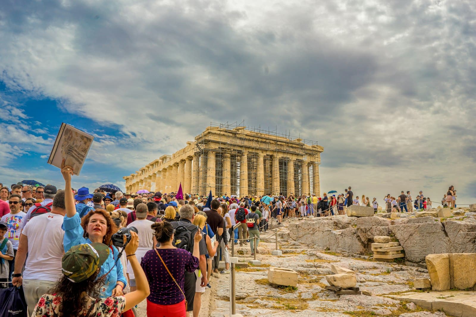A guide holding up a sign for a tour group at the Parthenon in Athens